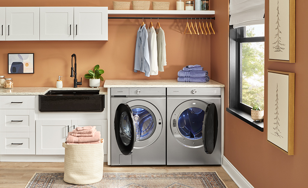 A stainless steel washer and dryer in a laundry room.