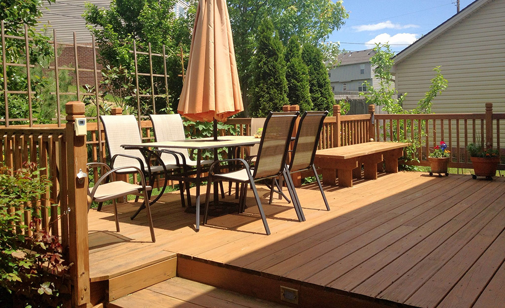 A large wood deck with patio furniture.