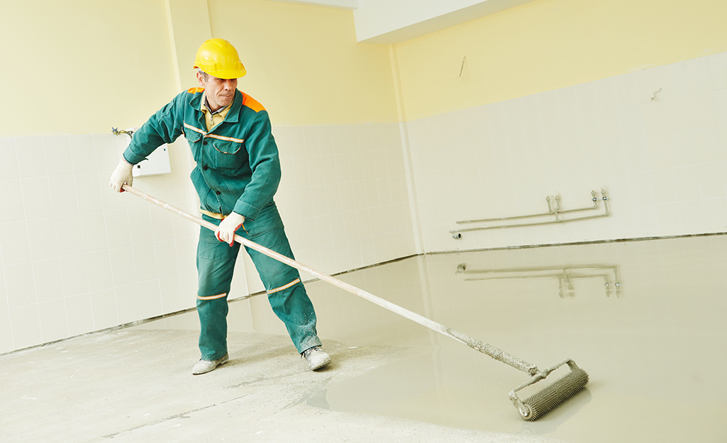 Person applying sealer to a basement.