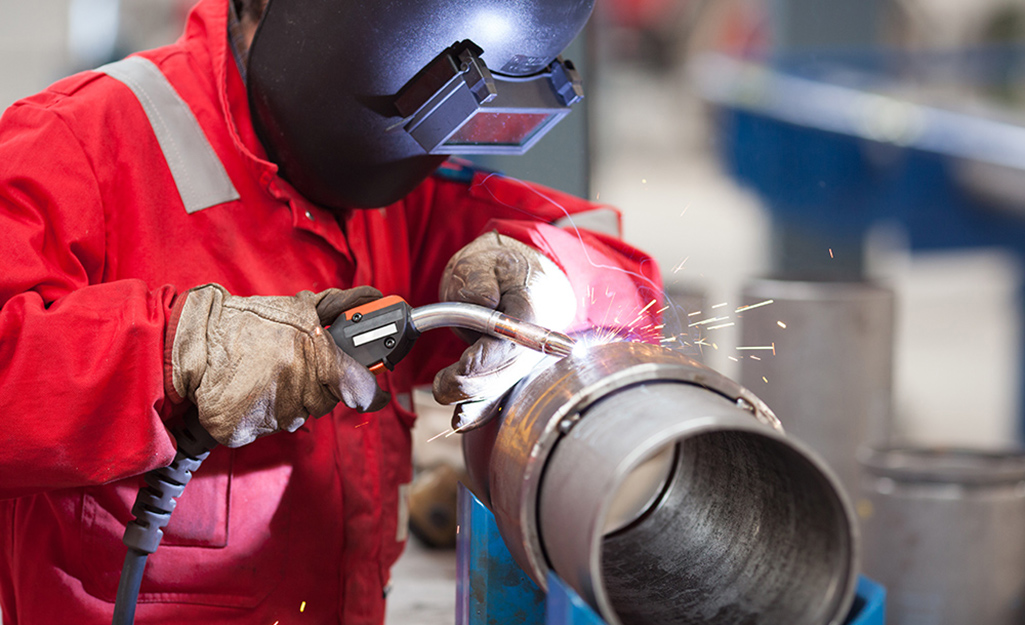 A person welds metal.
