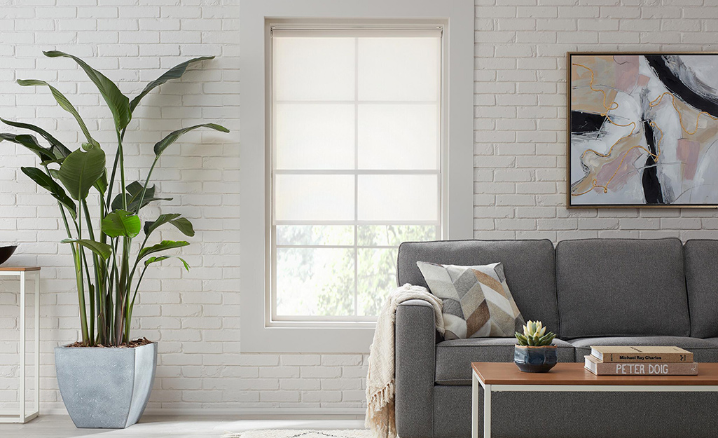 A window covered with sheer blinds in a living room.