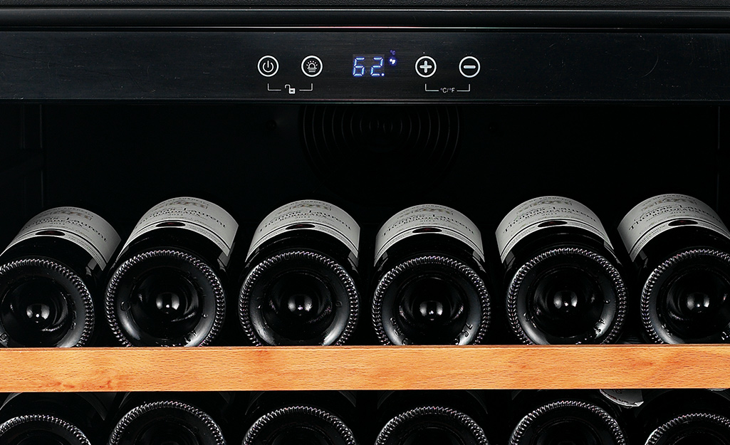 A wine cooler thermometer set to 62 degrees. 