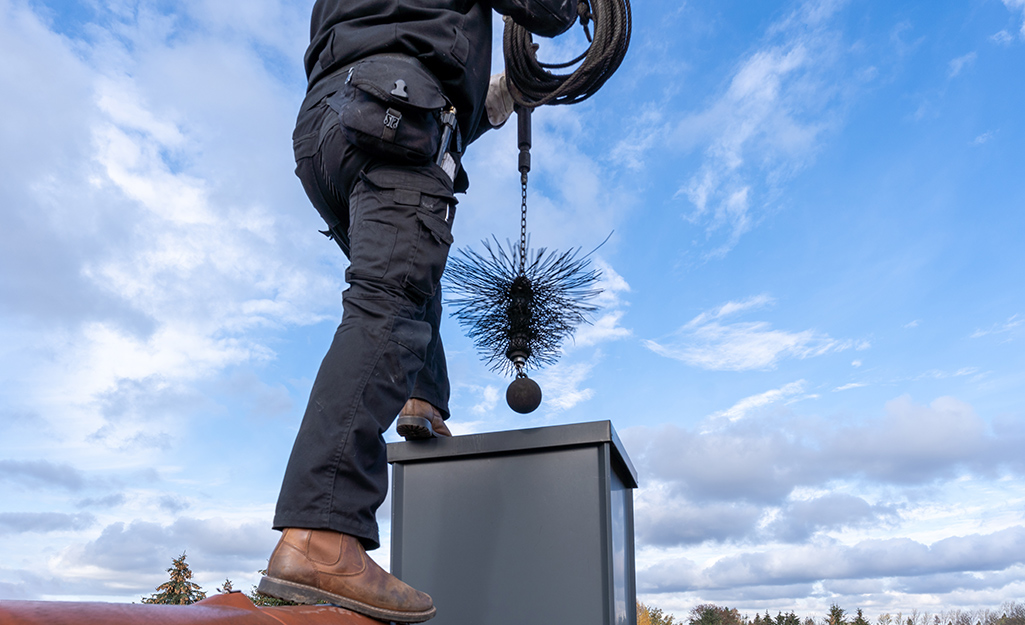 Professional cleaning a chimney.