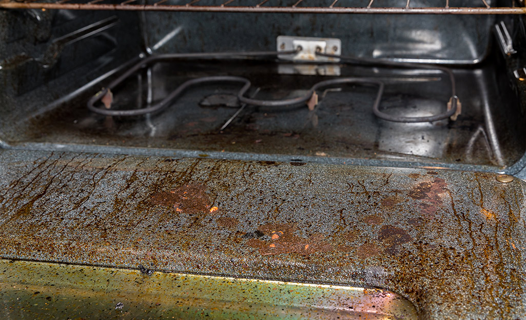 The grimy surface of an oven door and interior. The grimy surface of an oven door and interior.