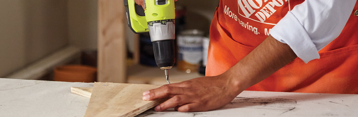 Man drilling the brim piece and hat piece together. Man drilling the brim piece and hat piece together.