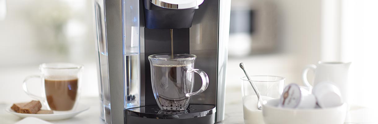 A Keurig machine making coffee A Keurig machine making coffee