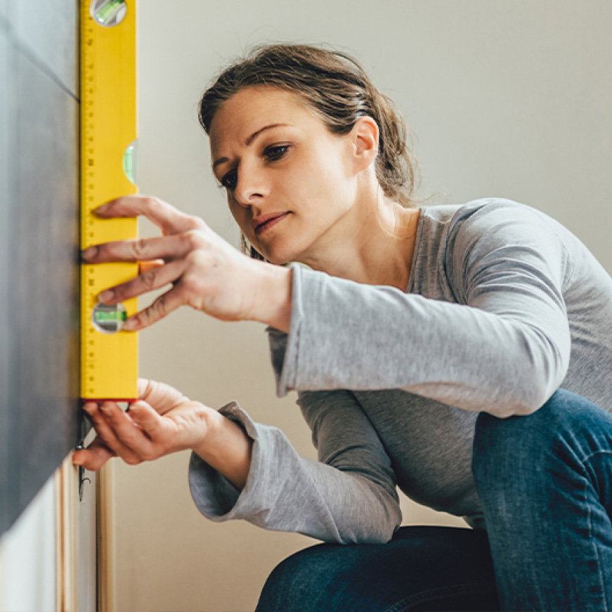 Woman using a level Woman using a level