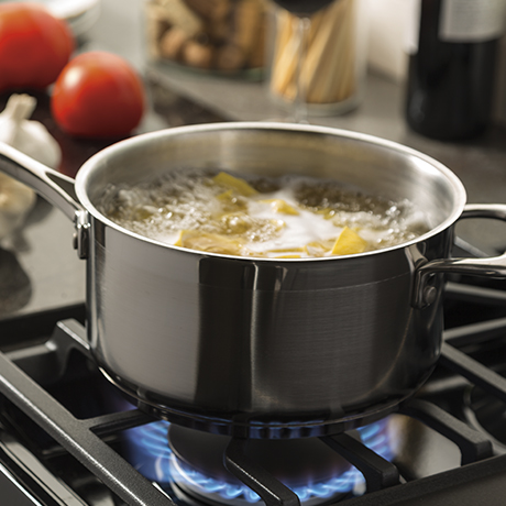 An intense gas burner creates high heat to boil water quickly.