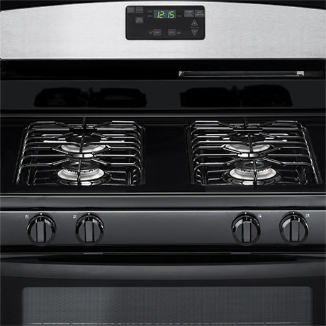 The black cooktop features four stainless steel sealed burners under black grates.