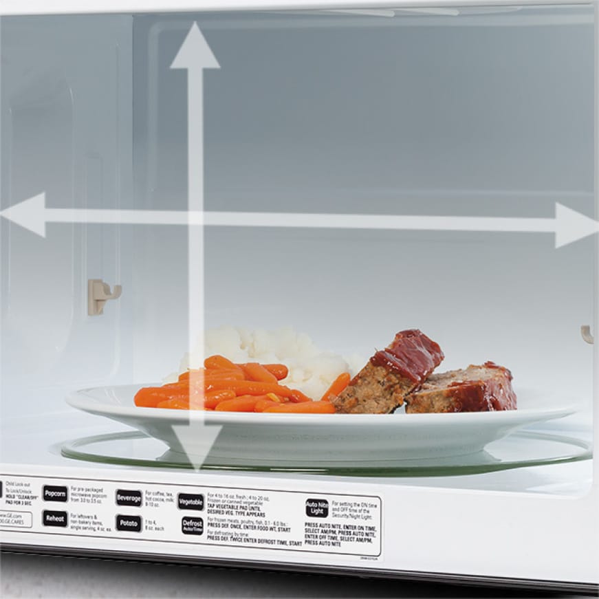 Image of microwave interior with dinner plate on turntable and arrow graphics indicating large capacity