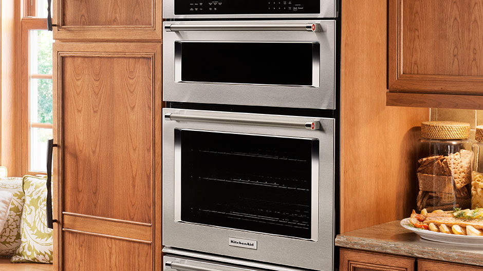 Stainless steel combination wall oven set in a classic kitchen.