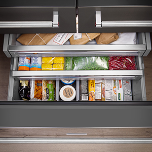 Freezer drawer fully extended with top two tiers stepped out above. Each level is filled with frozen items. Freezer drawer fully extended with top two tiers stepped out above. Each level is filled with frozen items.