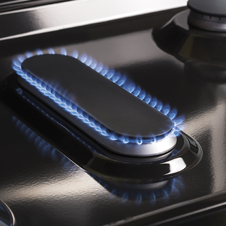 A large oval fifth burner on the gas cooktop is ideal for evenly heating a griddle.