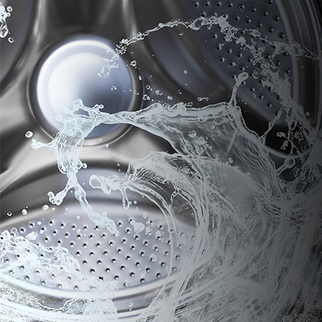 Close up interior of an empty LG washing machine with water swirling around