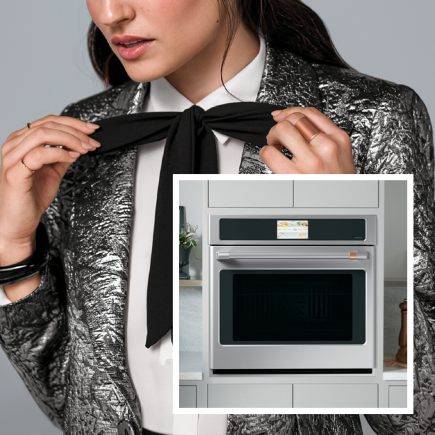 A woman dressed in fashionable clothing adjusts her ribbon-tie. A photo of a wall oven is superimposed in the lower-right corner. A woman dressed in fashionable clothing adjusts her ribbon-tie. A photo of a wall oven is superimposed in the lower-right corner.