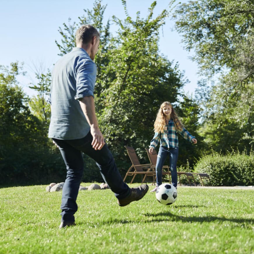 image of father and daughter playing soccer image of father and daughter playing soccer