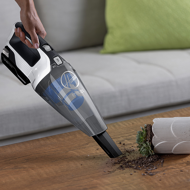 Hand vacuum sucking up dirt Hand vacuum sucking up dirt