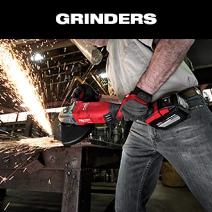 A man in jeans and gray t-shirt wearing work gloves uses an M18 FUEL Braking Grinder on metal as sparks fly.