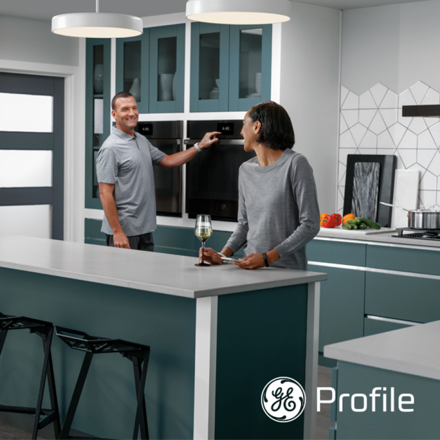 Angled image of couple laughing and interacting in kitchen. Angled image of couple laughing and interacting in kitchen.