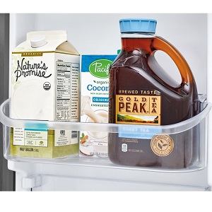 Sweet tea and milk in refrigerator door.