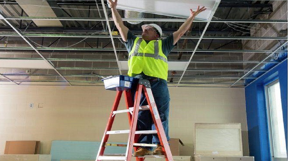 Pro painter using a fiberglass step ladder Pro painter using a fiberglass step ladder