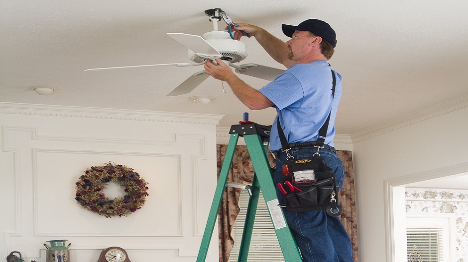 Pro painter using a fiberglass step ladder Pro painter using a fiberglass step ladder