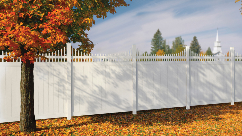 A view of the 6 ft x 8 ft Woodbridge Privacy Cut Scalloped Picket Top fence panel dividing two properties in an country setting. A view of the 6 ft x 8 ft Woodbridge Privacy Cut Scalloped Picket Top fence panel dividing two properties in an country setting.