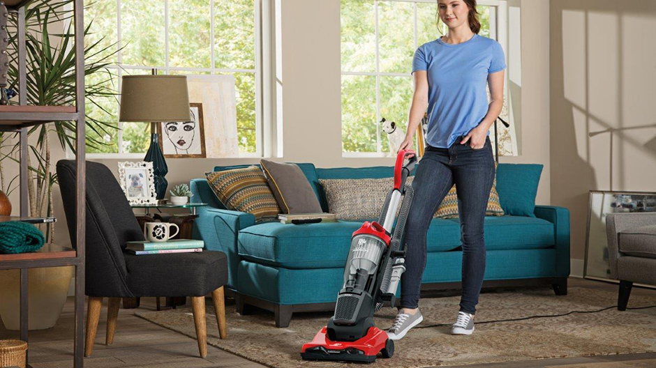 A college student using the Dirt Devil Endura Reach Upright Vacuum to clean their living room. A college student using the Dirt Devil Endura Reach Upright Vacuum to clean their living room.