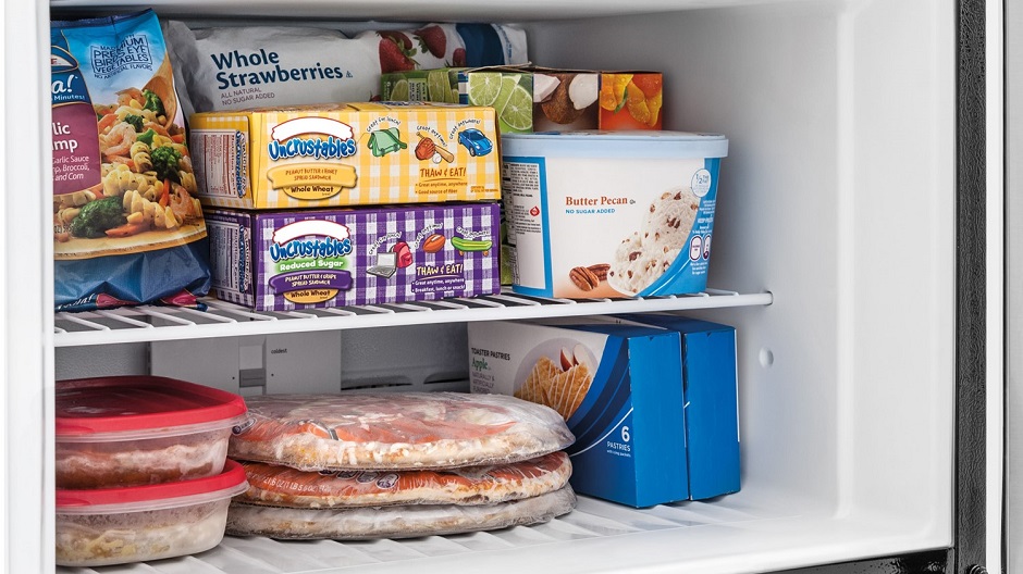 Frozen food on wire freezer shelf.