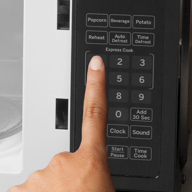 A hand presses one of the express cook buttons, cooking for 1 minute