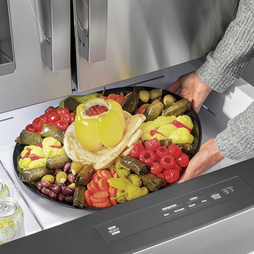 A party tray of vegetable is placed into the extra drawer